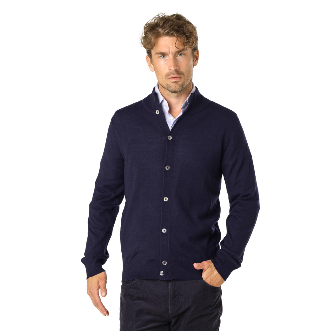 Model wearing the Merino Cardigan over a light shirt, paired with dark trousers for a casual yet polished look.