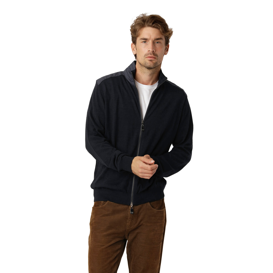 Model wearing the navy Zip Cardigan Merino layered over a shirt, paired with dark jeans for a smart-casual look.